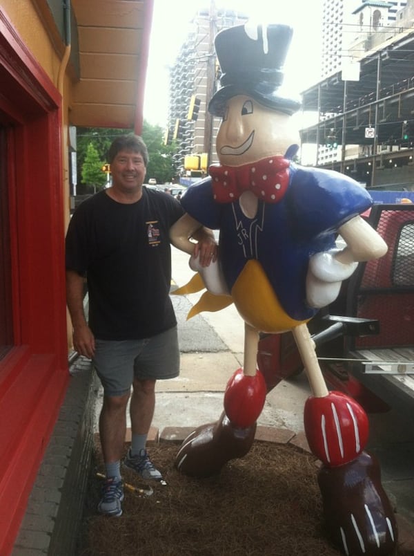  J.R. Crickets founder Paul Juliano poses with the sign that sits outside of the Midtown location. CONTRIBUTED BY J.R. Crickets