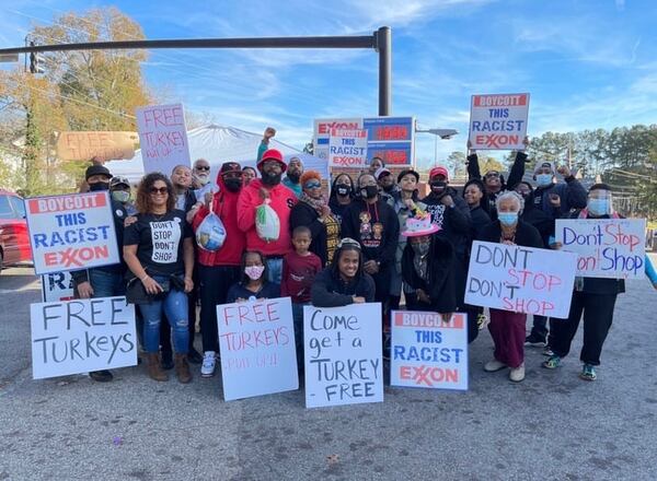 A group protesting the ownership of an Exxon station at 2345 Flat Shoals Road in DeKalb County poses for a photo while distributing free turkeys during the week of Thanksgiving 2020. SPECIAL PHOTO / B.J. ORR