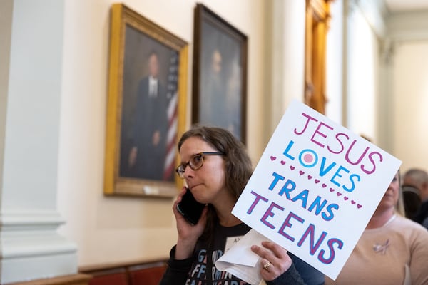 Alyssa Sali holds a sign outside the Senate at the Capitol in Atlanta on Monday, March 20, 2023. Activists appeared at the Capitol to protest Senate Bill 140, a bill that would prevent medical professionals from giving transgender children certain hormones or surgical treatment. (Arvin Temkar/The Atlanta Journal-Constitution)