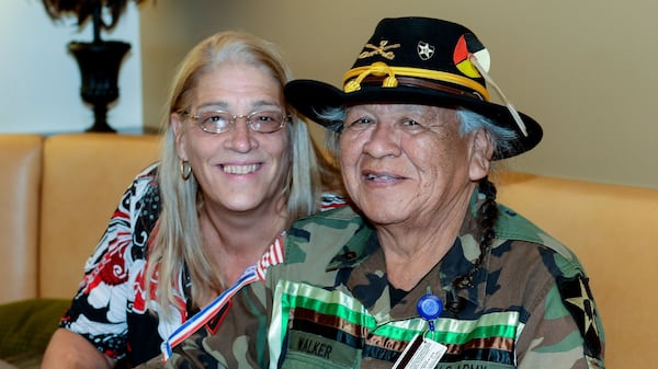 Levi Walker, who served as the Braves’ mascot Chief Noc-A-Homa from 1969 through 1985, and his wife, Teri Ficula, visit the SunTrust Club at Turner Field before a game against the Washington Nationals, Wednesday, Sept. 30, 2015, in Atlanta. This is Walker’s first Braves game since 1988. (AP Photo/Jon Barash)