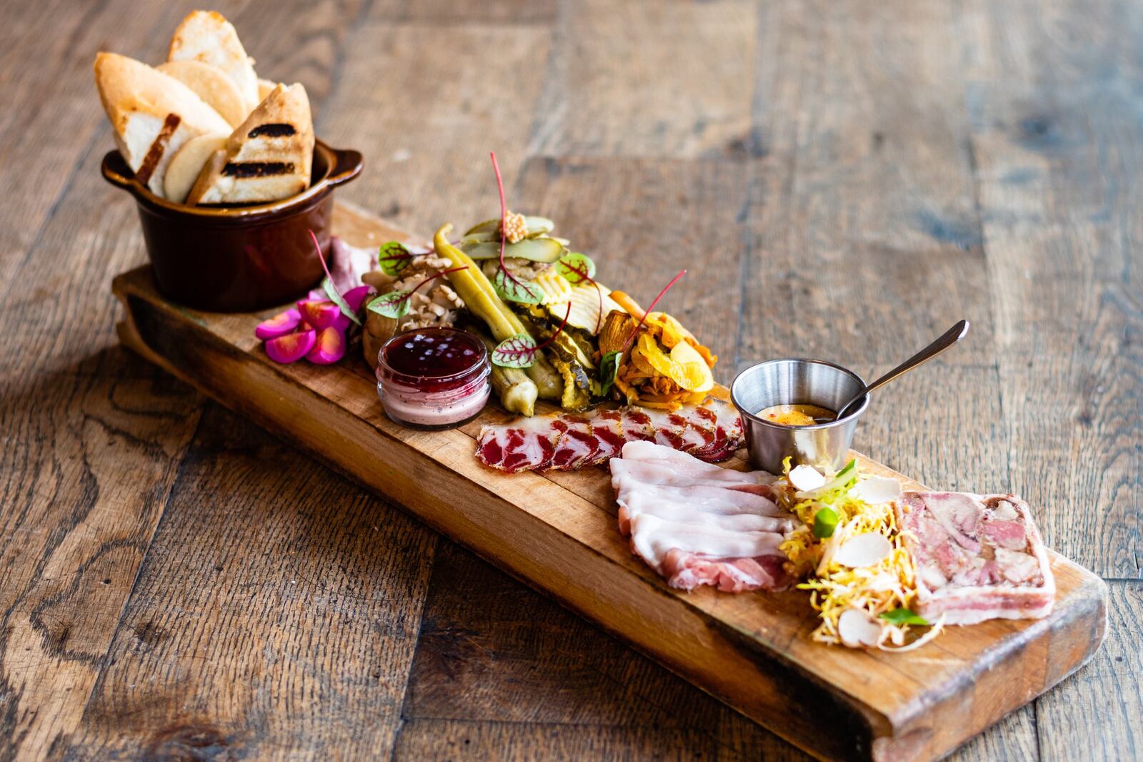 The charcuterie plate at Watershed showcases numerous house-made products. Recent meat boards have featured corned beef heart, chicken liver and duck pate, Ossabaw coppa, prosciutto from Stone Mountain and hog’s head terrine. CONTRIBUTED BY HENRI HOLLIS