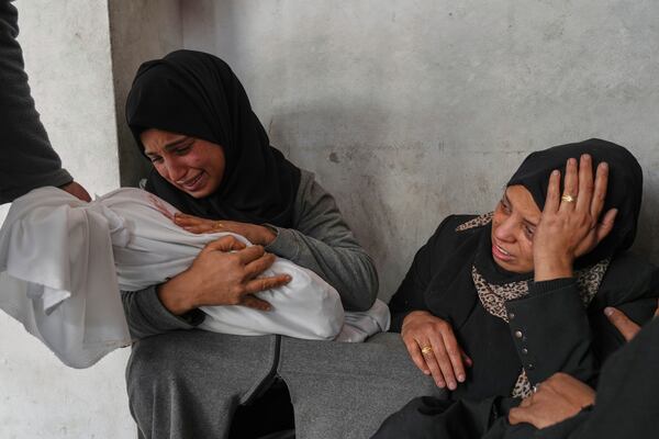 Amani Abu Aker holds the body of her 2-year-old niece Salma, killed during an Israeli army strike, before their burial at the Baptist hospital in Gaza City, Monday March 4, 2025.(AP Photo/Jehad Alshrafi)