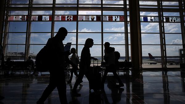 WASHINGTON, DC - JUNE 29:  Travelers walk to their gates in the concourse of Reagan National Airport in Washington, DC. (Photo by Win McNamee/Getty Images)