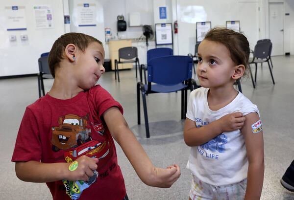 Twin siblings Luca, left, and Quincy Yacoub show off their bandages after getting a COVID-19 vaccine at the Southern Nevada Health District in Las Vegas on June 22, 2022. (K.M. Cannon/Las Vegas Review-Journal/TNS)