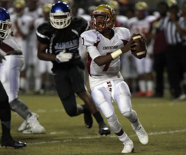 Creekside Seminoles QB Felix Harper looks to pass during action in the second quarter. Stephenson Jaguars match up against the Creekside Seminoles in a high school football game at Hallford Stadium Friday, September 18, 2015. KENT D. JOHNSON/KDJOHNSON@AJC.COM