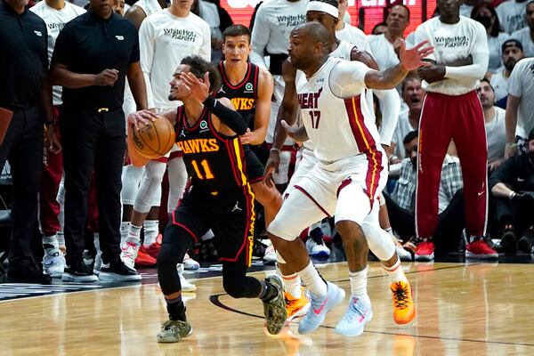 Atlanta Hawks guard Trae Young (11) reacts after being fouled by Miami Heat forward P.J. Tucker (17) during the second half of Game 2 of an NBA basketball first-round playoff series, Tuesday, April 19, 2022, in Miami. The Heat won 115-105. (AP Photo/Lynne Sladky)