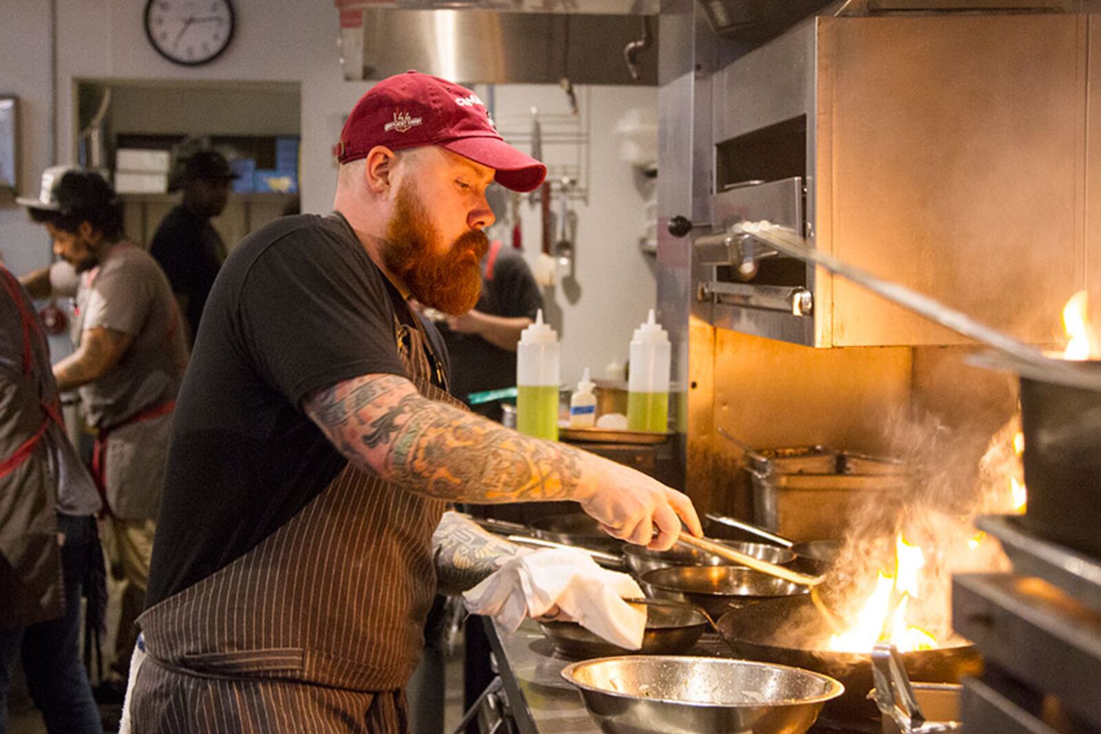 Kevin Gillespie serves a dish for the dinner crowd May 8, 2018 at Gunshow in Atlanta. Gillespie was recently diagnosed with renal cancer and will have to undergo treatment. (REANN HUBER/REANN.HUBER@AJC.COM)