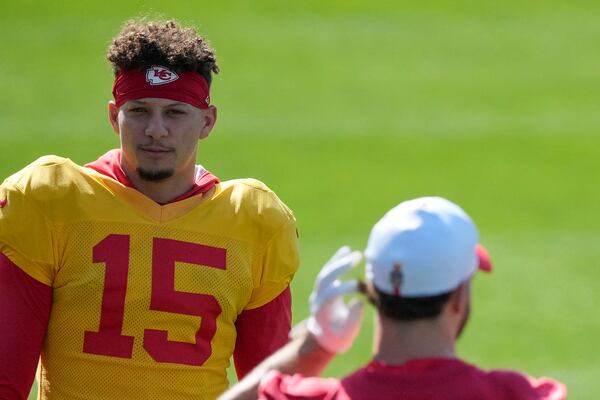 Kansas City Chiefs quarterback Patrick Mahomes (15) talks with tight end Anthony Firkser (85) during an NFL football practice Wednesday, Feb. 5, 2025, in New Orleans, ahead of Super Bowl 59 against the Philadelphia Eagles. (AP Photo/Brynn Anderson)