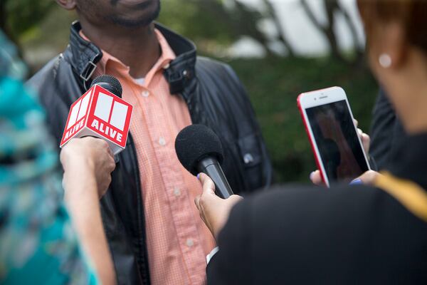 10/14/2019 -- Decatur, Georgia -- Members of the media speak to Juror 31, of the Robert "Chip" Olsen trial, following the verdict in front of the DeKalb County Courthouse in Decatur, Monday, October 14, 2019. Juror 31, a 36-year-old father, asked that his identity be concealed because of the nature of the case. On the sixth day of jury deliberations the jury found Robert "Chip" Olsen not guilty of felony murder. But jurors reached guilty verdicts on four lesser charges: two counts of violation of oath of office, aggravated assault and making a false statement. (Alyssa Pointer/Atlanta Journal Constitution)