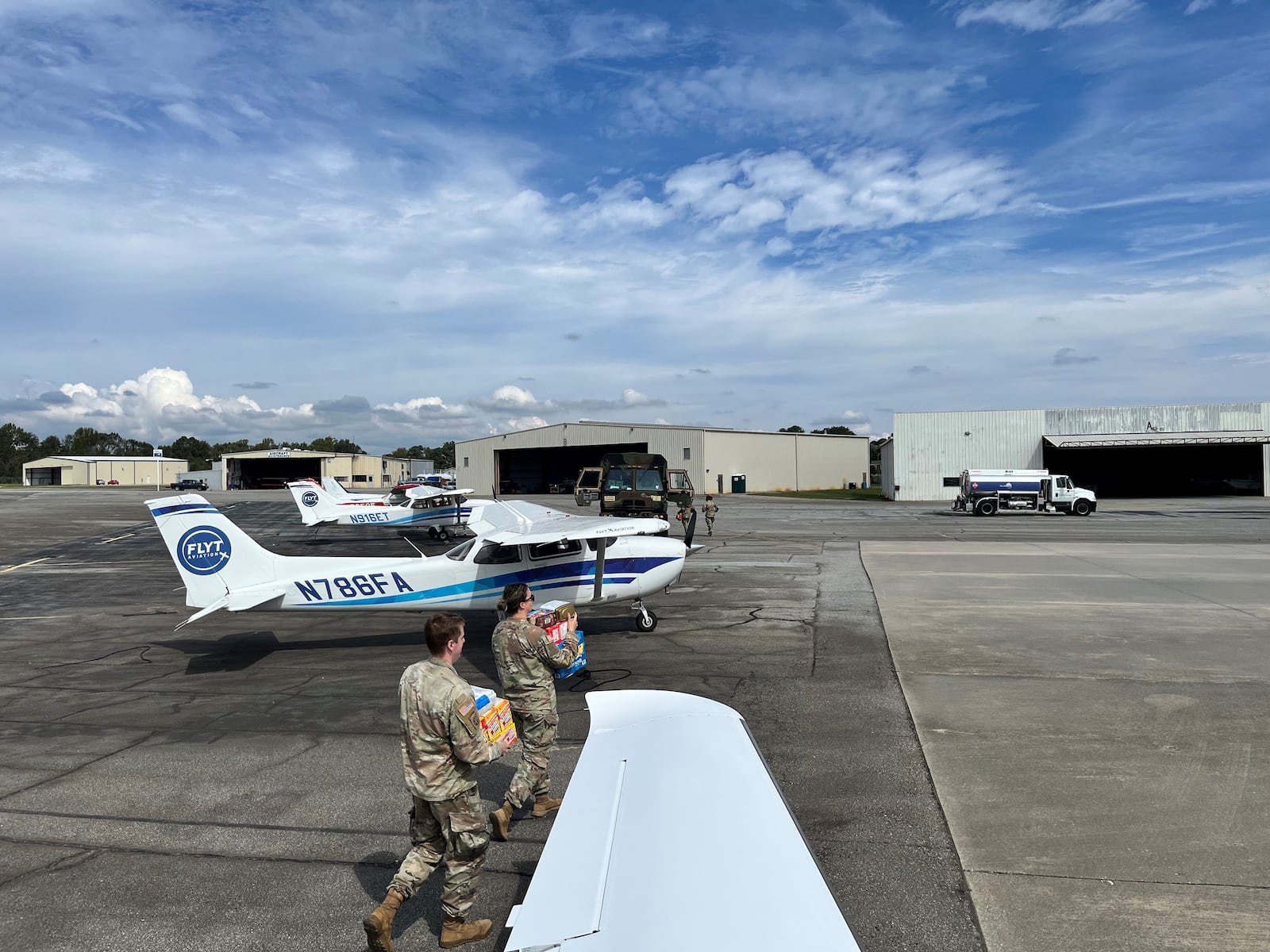 States guardsmen carry supplies from Bert Light's plane in Spartanburg, South Carolina, on Friday, Oct. 4, 2024. Light is a volunteer pilot who brought donations to communities after Hurricane Helene. Contributed