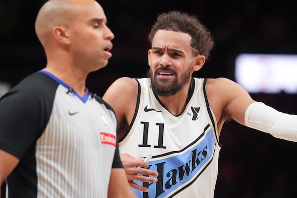 Atlanta Hawks guard Trae Young (11) talks with an official in the first half of an NBA basketball game against the Los Angeles Lakers, Friday, Dec. 6, 2024, in Atlanta. (AP Photo/Brynn Anderson)