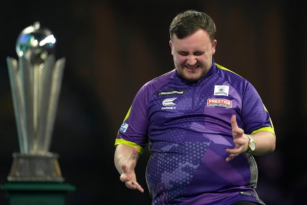 FILE - Luke Littler grimaces during the final match against Luke Humphries of England at the World Darts Championship, in London, Wednesday, Jan. 3, 2024. (AP Photo/Kin Cheung, File)