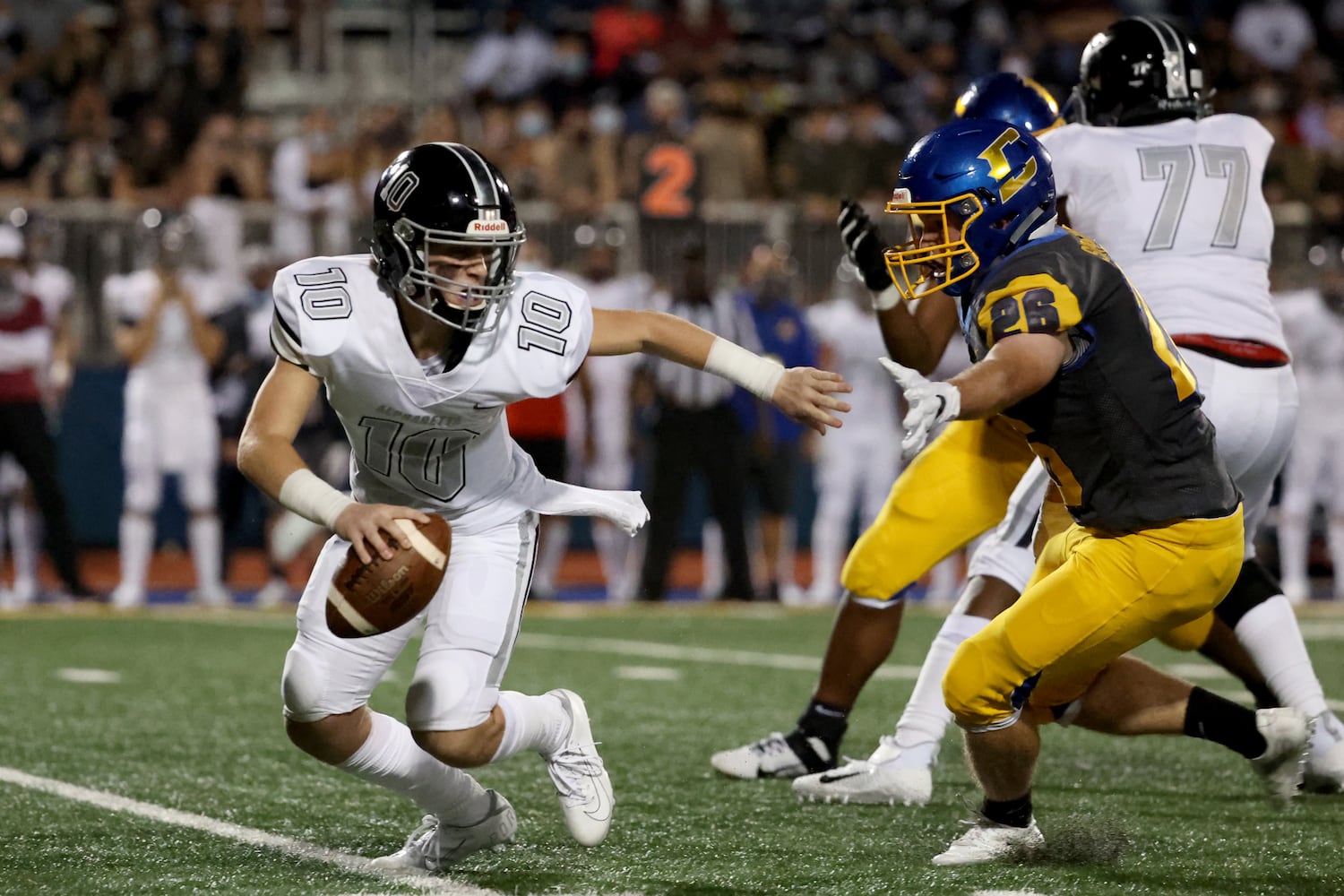 Alpharetta quarterback Ben Guthrie (10) eludes the tackle from Chattahoochee linebacker Billy Spradlin (26) in the first half at Chattahoochee high school Friday, September 25, 2020 in Johns Creek, Ga.. JASON GETZ FOR THE ATLANTA JOURNAL-CONSTITUTION