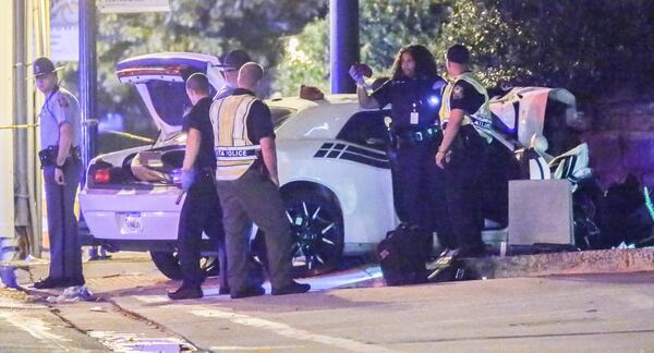 A fatal crash investigation closed Peachtree Street near the Invesco building Wednesday. JOHN SPINK / JSPINK@AJC.COM