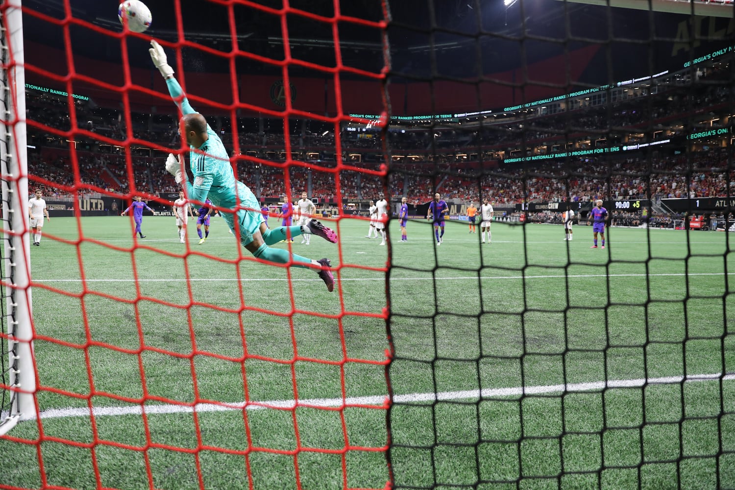 With an impressive catch, Columbus Crew goalkeeper Eloy Room (1) deflects a shot from Marcelino Moreno during the second half of an MLS soccer match at Mercedes-Benz Stadium on Saturday, May 28, 2022. Miguel Martinez / miguel.martinezjimenez@ajc.com