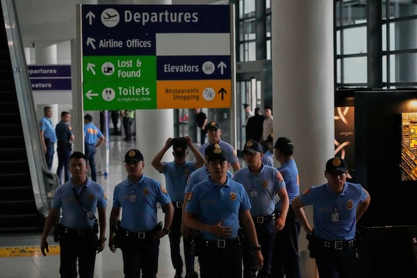 Security officers patrol the airport after former President Rodrigo Duterte was arrested, in Manila, Philippines, Tuesday, March 11, 2025. (AP Photo/Aaron Favila)