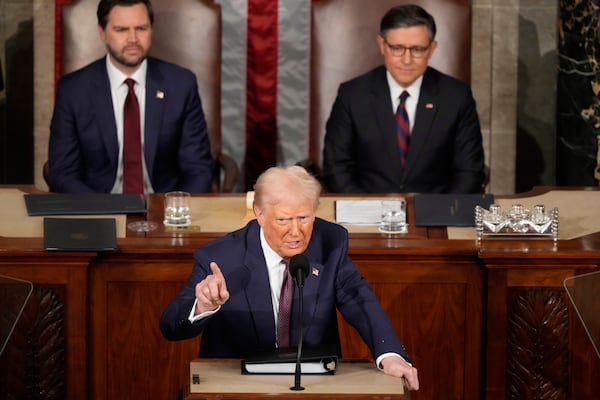 President Donald Trump speaks as Vice President JD Vance, left, and House Speaker Mike Johnson of La., listen as Trump addresses a joint session of Congress at the Capitol in Washington, Tuesday, March 4, 2025. (AP Photo/Ben Curtis)