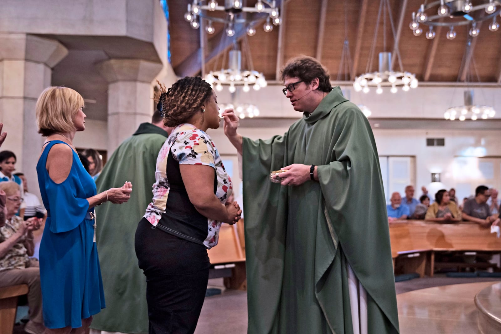 Father Joshua Whitfield shown during Holy Communion. Photo courtesy of Jenna Teter, The Texas Catholic Newspaper