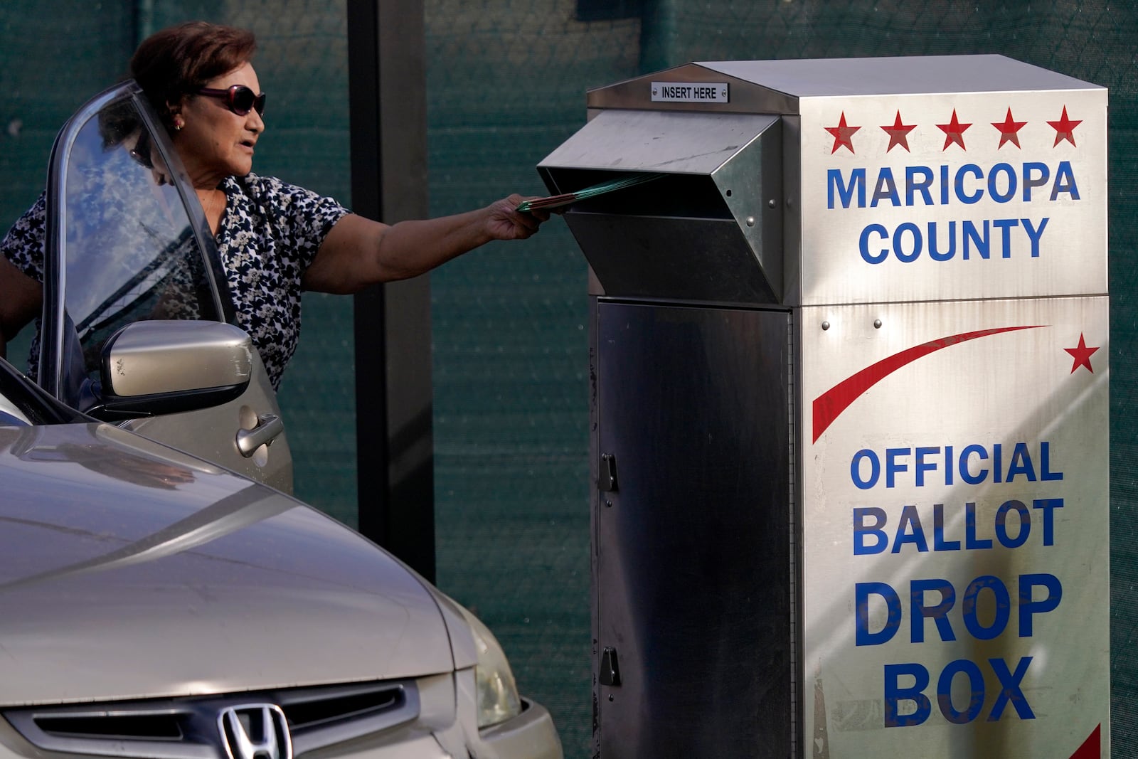 FILE - A voter casts their ballot at a secure ballot drop box at the Maricopa County Tabulation and Election Center in Phoenix, Nov. 1, 2022. (AP Photo/Matt York, File)