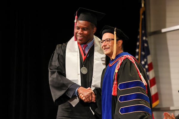 Former Georgia running back Herschel Walker walks across the stage during the fall graduation ceremony for the University of Georgia’s College of Family and Consumer Sciences, at Mahler Hall, Thursday, December 12, 2024, in Athens, Ga. (Jason Getz/AJC)
