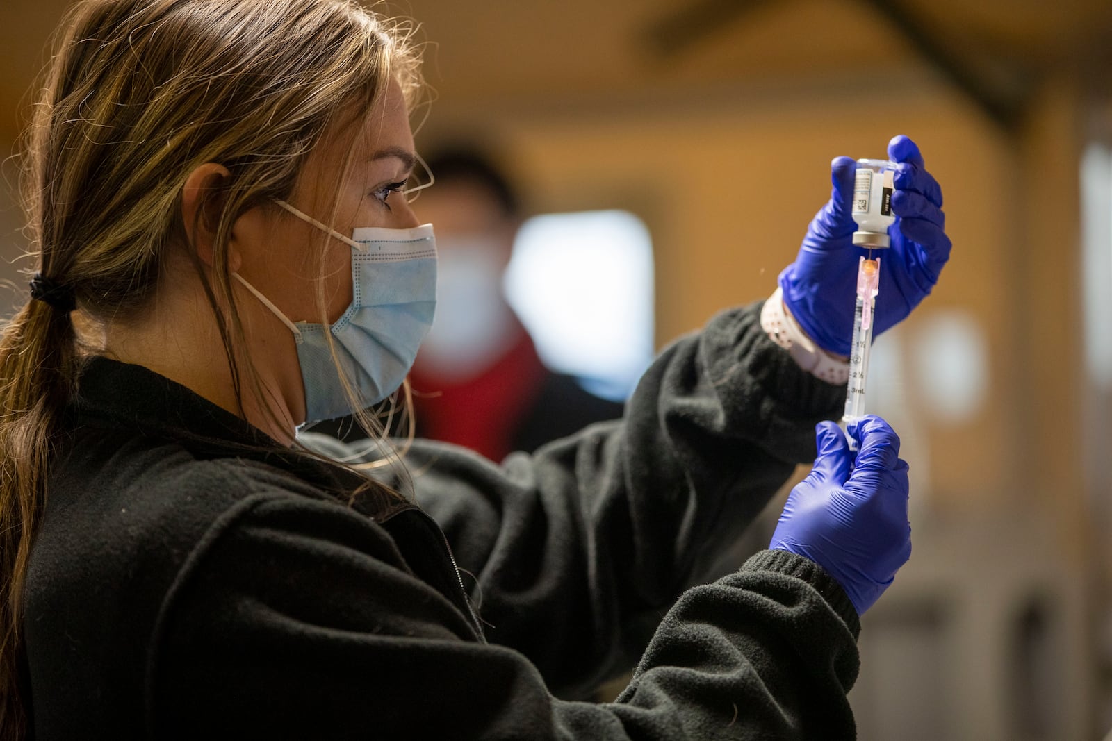  Kennesaw State University Nursing Student Julia Taylor prepares a single does of the Moderna COVID-19 vaccine for a patient at a drive thru vaccination at Jim Miller Park in Marietta Wednesday. (Alyssa Pointer / Alyssa.Pointer@ajc.com)