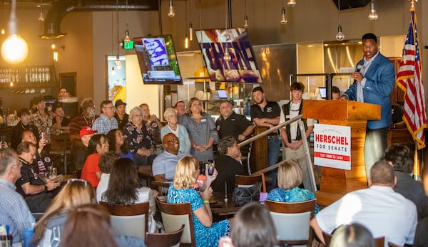 Herschel Walker campaigns at Mojitos Bistro in Norcross on Monday, September 26, 2022  in his bid for congress with support from Utah Congressman Burgess Owens, Florida Congressman Byron Donalds and Walker's wife, Julie Blanchard, ahead of the November elections.  (Jenni Girtman for The Atlanta Journal-Constitution)