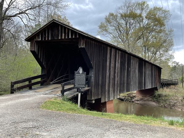 The Red Oak Covered Bridge in Woodbury, dating from the 1840s, was built by Horace King or his son. King, born into slavery, was widely respected as a builder and an engineer. The bridge is listed as part of the Georgia Trust for Historic Preservation's Places in Peril, historic structures and locales that are in danger from neglect or development. Photos: courtesy Halston Pitman/Walter Sippel/MotorSportMedia.