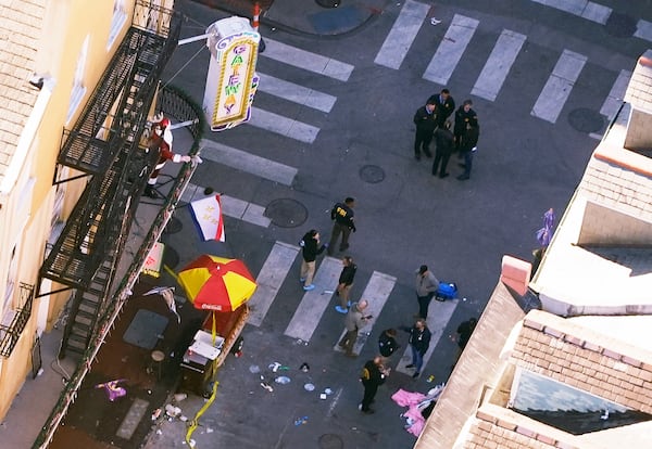 Investigators work the scene after a person drove a vehicle into a crowd killing several, earlier on Canal and Bourbon Street in New Orleans, Wednesday, Jan. 1, 2025. (AP Photo/Gerald Herbert)