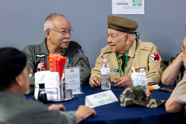 Lat Nguyen and Oanh Vu chat at a Veterans Day ceremony honoring Vietnamese-American veterans at First Senior Center of Georgia in Norcross on Monday, Nov. 11, 2024. (Arvin Temkar / AJC)