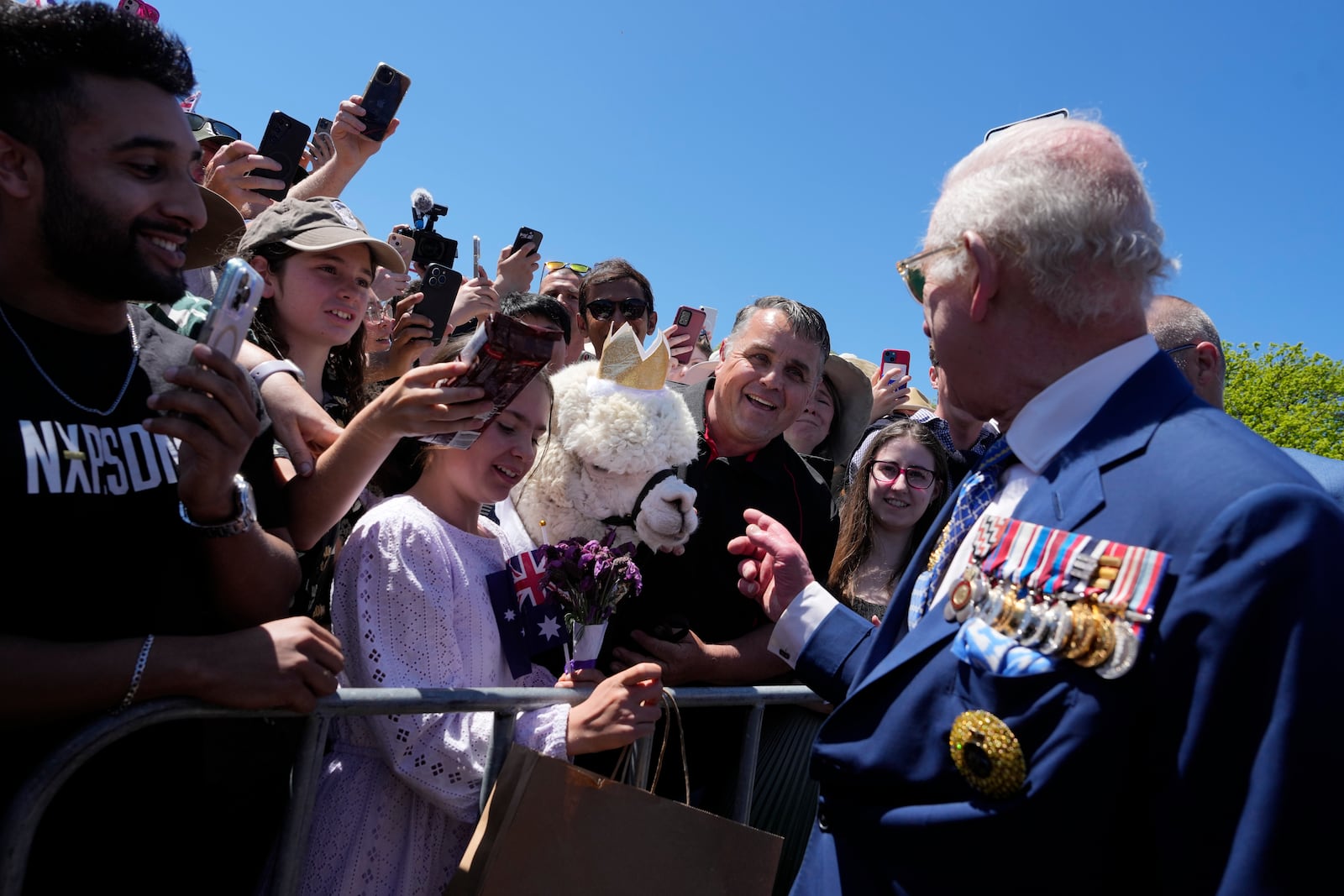 Britain's King Charles III, tight, chat with owner of alpaca before leave the Australian War Memorial in Canberra, Monday, Oct. 21, 2024. (AP Photo/Mark Baker, Pool)