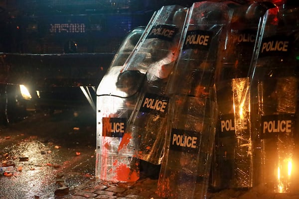 Police block a street to prevent protesters during a rally against the government's decision to suspend negotiations on joining the European Union for four years, outside the parliament in Tbilisi, Georgia, on Sunday, Dec. 1, 2024. (AP Photo/Zurab Tsertsvadze)