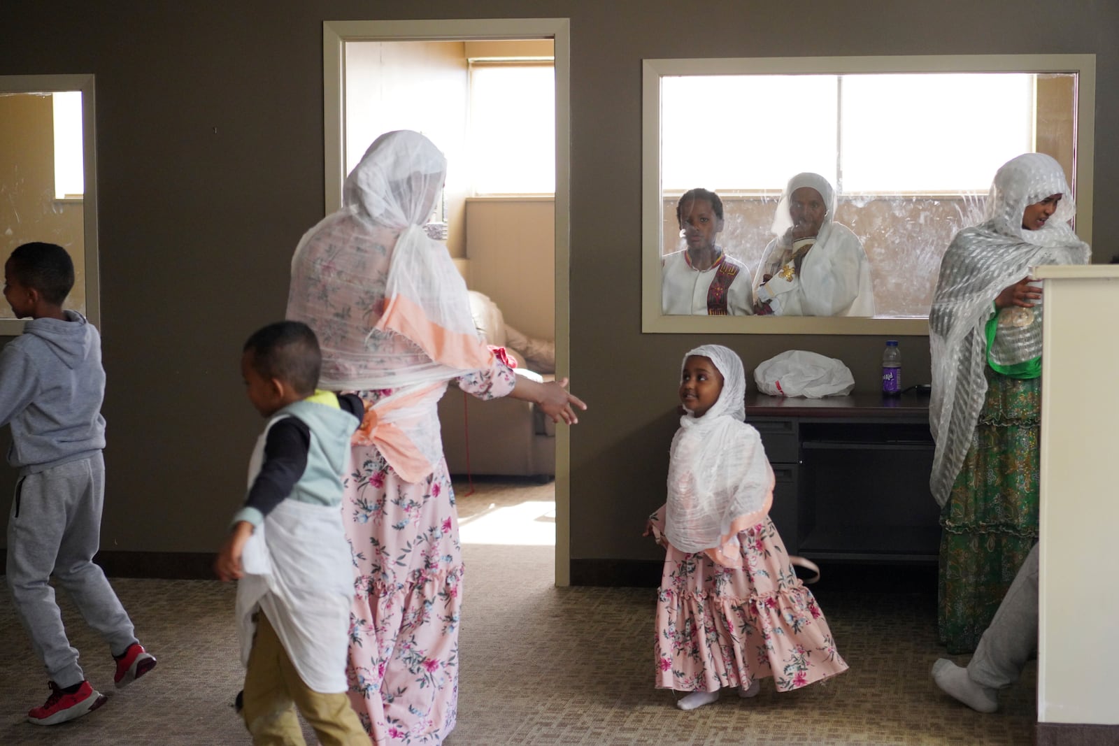 Members of the Ethiopian Orthodox Tewahedo Church visit after service on Sunday, Oct. 20, 2024, in Worthington, Minn. (AP Photo/Jessie Wardarski)