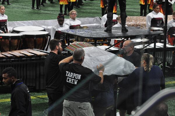 Seeking cover from a leaking roof at Mercedes-Benz Stadium.