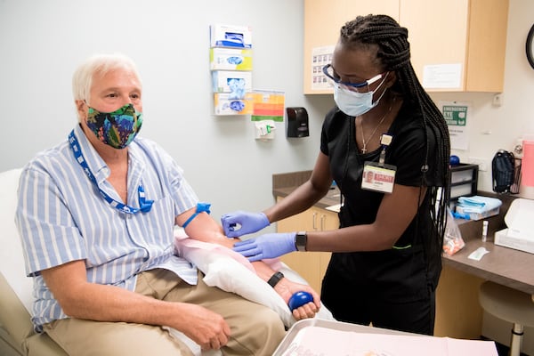 Jack Krost participates in Phase 3 of the COVID-19 vaccine trial at Emory University’s Hope Clinic. He’s being treated by Juton Winston, clinical research coordinator at the Hope Clinic. PROVIDED BY EMORY UNIVERSITY