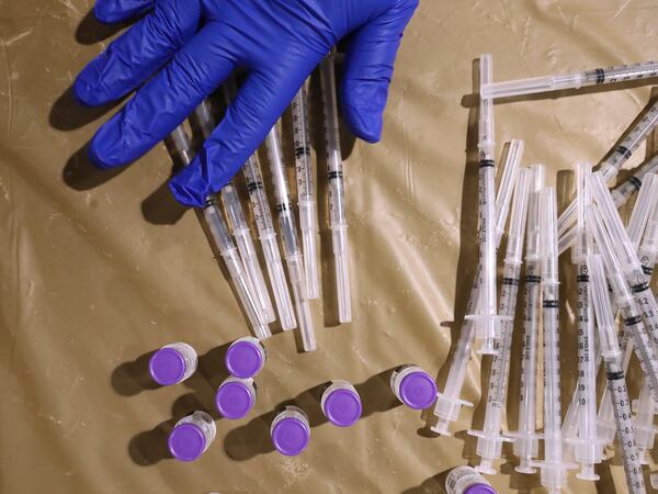 Nurse practitioner Debra Dewitt, with the Fulton County Board of Health, prepares Pfizer vaccines at the mass vaccination site at Mercedes-Benz Stadium on Wednesday. (Curtis Compton / Curtis.Compton@ajc.com)