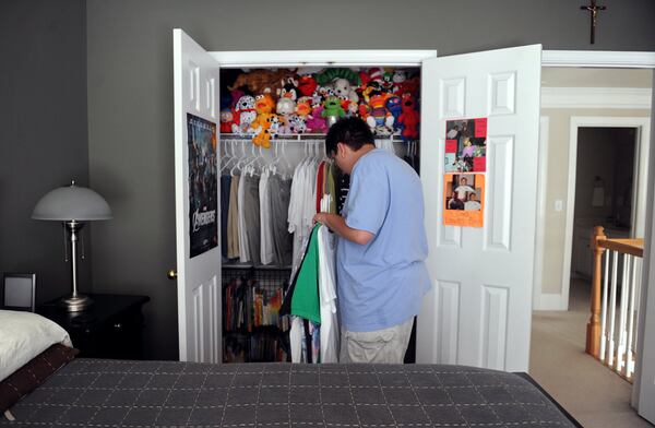 May 17, 2012 Acworth -- Benjamin Lust, 21, has autism, which requires him to have care 24/7. He's shown here putting away his clean laundry at his Acworth home Thursday, May 17, 2012. Ben is covered by Medicaid for medical issues -- and his mother hopes that her foresight in placing him on a waiting list 10 years ago will help him get coverage through a Medicaid waiver to provide supervision and support after he ages out of the public school system this year. Getting that is crucial for this family. Benjamin is very non-verbal -- but he's interested in all sorts of things: he's into computers, reading, geography. His mother says he has a photographic memory. He's one of four children and his parents are now divorced. Benjamin's room is so neat and tidy, and so is his closet, but I was surprised to see the color of the neatly-arranged stuffed animals when he opened his closet door to put away his clothes. I just like how this photo shows that 21-year-old Benjamin is hovering somewhere between his childhood interests and his adult physical age. BITA HONARVAR / BHONARVAR@AJC.COM