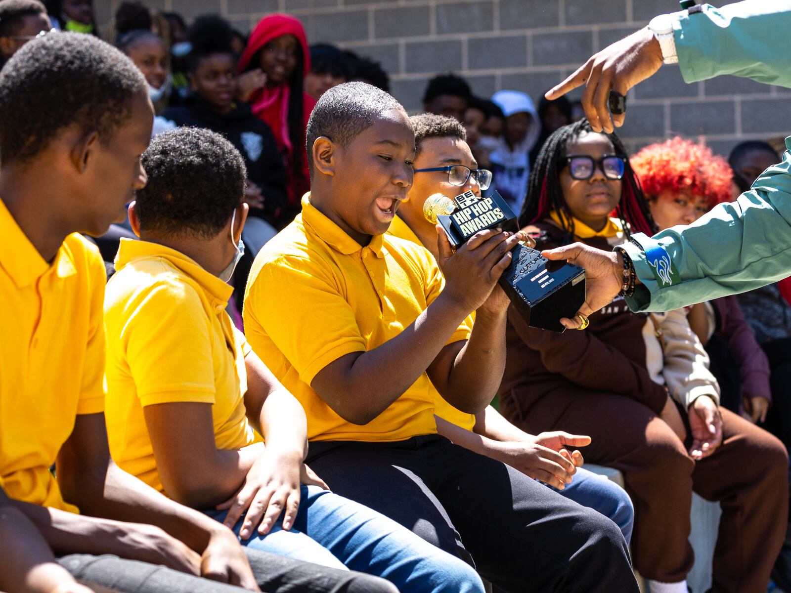 A student holds a BET Hip Hop Award earned by hip-hop group Earthgang before a new community garden is unveiled at Jean Childs Young Middle School in Atlanta on Thursday, March 30, 2023. Earthgang helped sponsor the project. (Arvin Temkar / arvin.temkar@ajc.com)