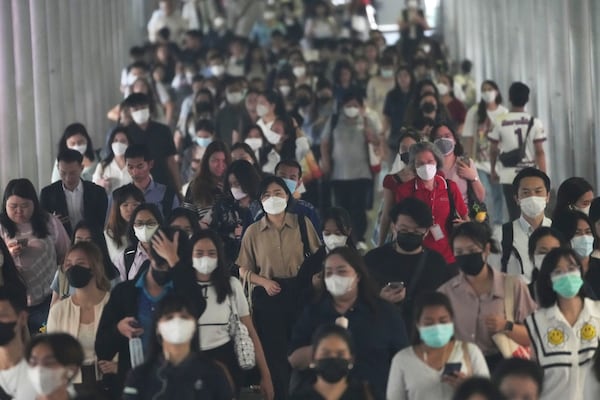 FILE - Peoples wear face masks to protect themselves from air pollution in Bangkok, Thailand, Feb. 6, 2025, (AP Photo/Sakchai Lalit, File)