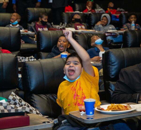 Eight-year-old Marco Espino gets ready for the movie to start.