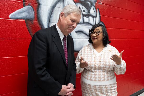 USDA Sec. Tom Vilsack and Rep. Nikema Willams talk during a press gaggle following a panel discussion at Tri-Cities High School in East Point on Tuesday, Jan. 23, 2024.   (Ben Gray / Ben@BenGray.com)