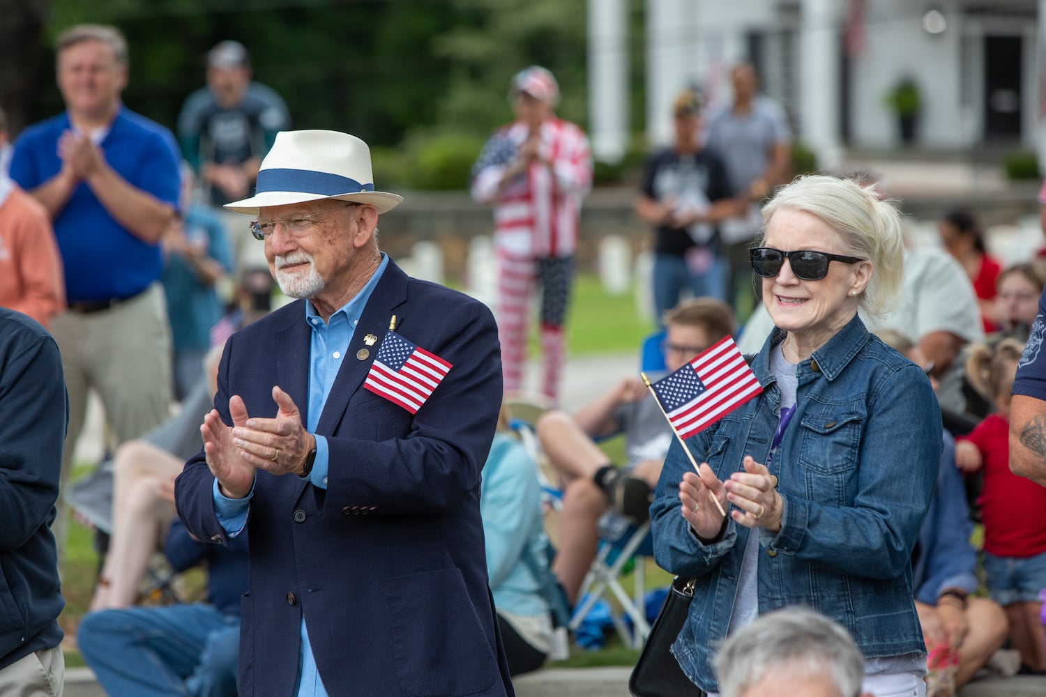 During a moment of silence for the soldiers lost since last Memorial Day, Army Aviation veteran Mark Maloney, left, and his sister Mary Chappell, right, participate in the 77th annual Memorial Day Observance at the Marietta National Cemetery on Monday, May 29, 2003.  (Jenni Girtman for The Atlanta Journal-Constitution)