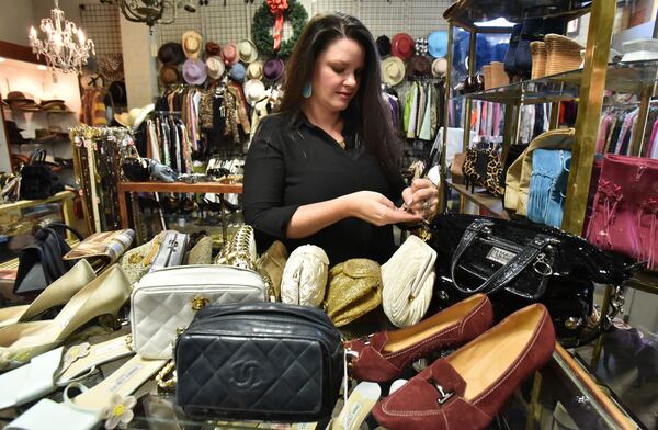 Christy Ogletree Ahlers, owner of Peachtree Battle Estate Sales and Liquidations, prepares for the estate sale of Diane McIver's wardrobe as she is surrounded by more than 2,000 of Diane McIver's clothing and jewelry items in a warehouse showroom at Peachtree Battle Estate Sales and Liquidations on Friday, December 2, 2016. HYOSUB SHIN / HSHIN@AJC.COM