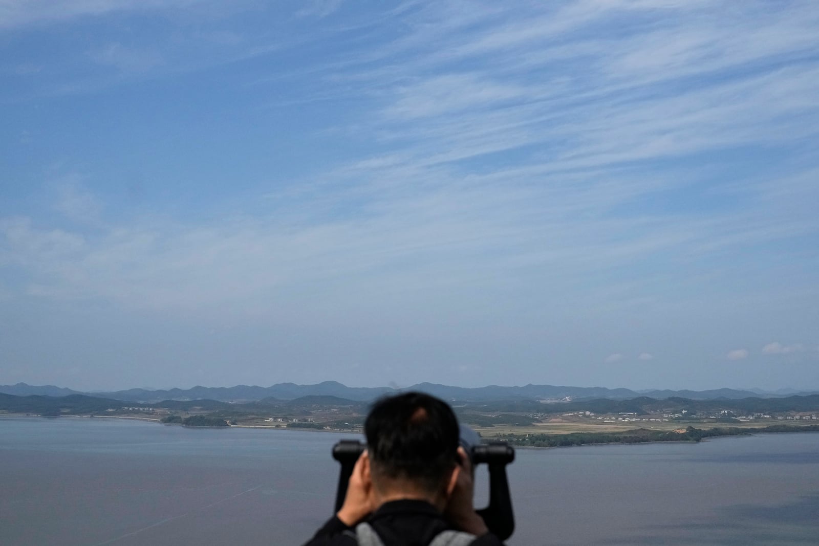 A visitor watches North Korean side from the Unification Observation Post in Paju, South Korea, Wednesday, Oct. 9, 2024. (AP Photo/Lee Jin-man)