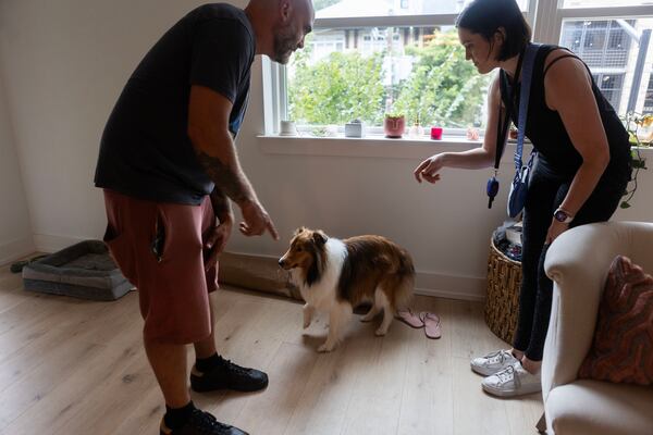 Anthony Todaro gives direction during dog training for, Sophie, alongside owner Elizabeth Ann Miller in Atlanta. (Michael Blackshire/Michael.blackshire@ajc.com)