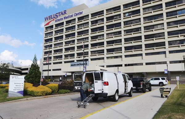 A man loads equipment into his van outside of the Atlanta Medical Center on Monday, October 31, 2022 as the hospital prepared to close at midnight. CHRISTINA MATACOTTA FOR THE ATLANTA JOURNAL-CONSTITUTION