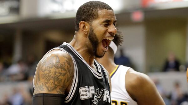 San Antonio's LaMarcus Aldridgeall sports a number of tattoos with biblical meanings. On his right arm he has a huge a cross and the words "keep God first."