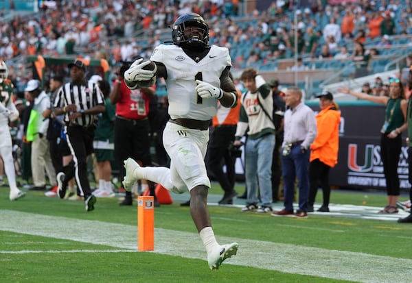 Wake Forest running back Demond Claiborne (1) runs back a kick return for a touchdown during the first half of an NCAA college football game against Miami, Saturday, Nov. 23, 2024, in Miami Gardens, Fla. (AP Photo/Lynne Sladky)