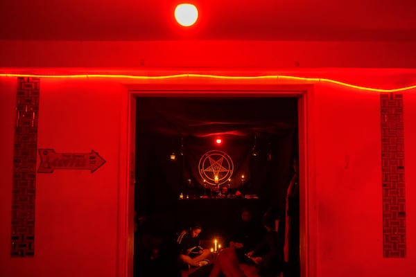 Satanist Kali Ma, a dentistry student who was born and raised in the heart of a Jehovah’s Witness family, reads verses after taking part in The Temple of Satan: Satanists and Luciferians of Chile's monthly ceremony in Santiago, Sept. 27, 2024. (AP Photo/Esteban Felix)