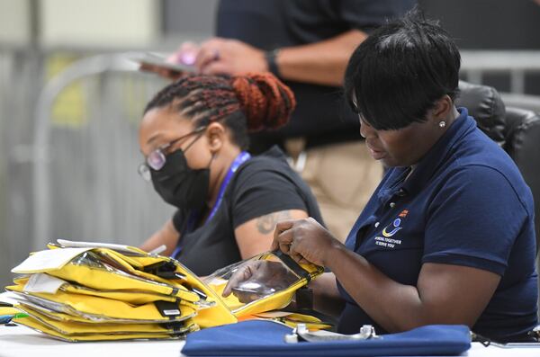 May 24, 2022  Atlanta - An election worker checks memory cards contained votes at Fulton County Election Preparation Center on Tuesday, May 24, 2022. (Hyosub Shin / Hyosub.Shin@ajc.com)