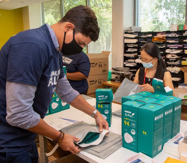 Global Ministries' Nazih Bouanani works with others to help package over 300 envelopes with 20 face masks each to send to people all over the USA at their Atlanta headquarters. PHIL SKINNER FOR THE ATLANTA JOURNAL-CONSTITUTION.